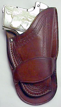 Colt Model N with Carved Steerhead pearl in single loop holster.